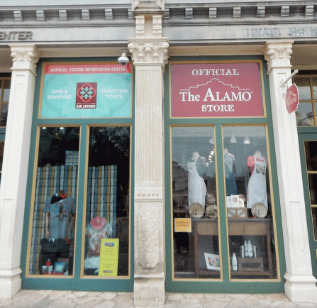 Store window of the San Antonio Visitor Information Center on the left and Official The Alamo Store on the right