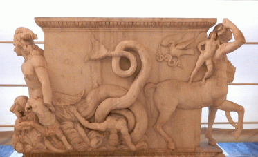 Table support, 2nd century, Villa Madama. "On it is depicted the Homeric myth of Scylla gripping Ulysses' sailors. The sea-monster that emerges from the woman's body, her arm thrown haphazardly over her head, encircles in the loops of her fish-like tail the lifeless body of a man. Meanwhile the three dogs' heads that emerge from her stomach wreak destruction on other shipwrecked sailors who struggle in the waves. A centaur is depicted on the opposite side... a small cupid seated on her back...."